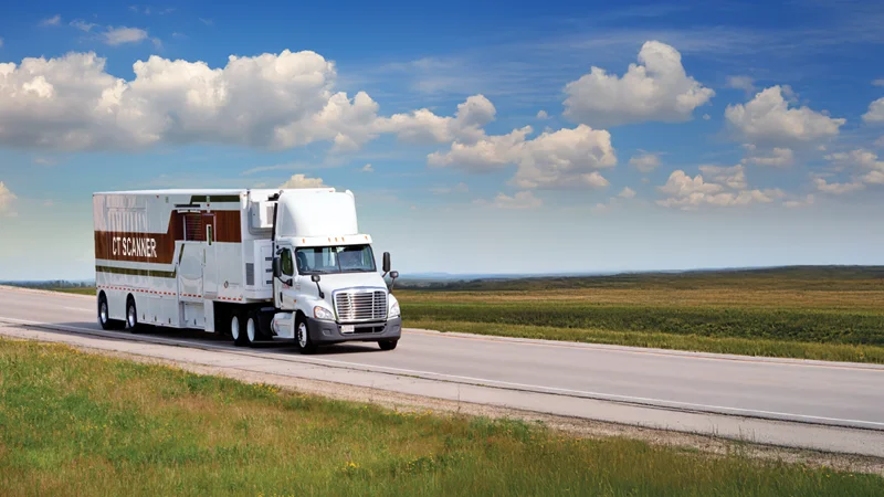 Shared Medical Services Mobile CT Scanner en route across open countryside, providing flexible imaging solutions directly to healthcare facilities.