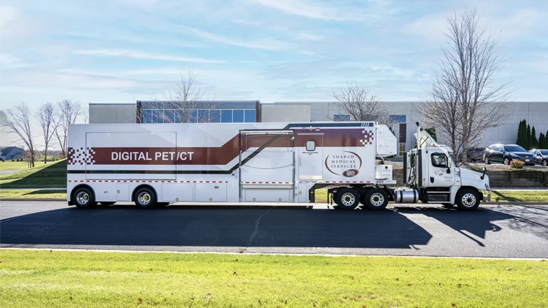 Fully equipped digital PET/CT trailer from Shared Medical Services en route to a healthcare facility, showcasing the flexibility and convenience of mobile imaging solutions for cardiology, oncology, and neurology diagnostics.