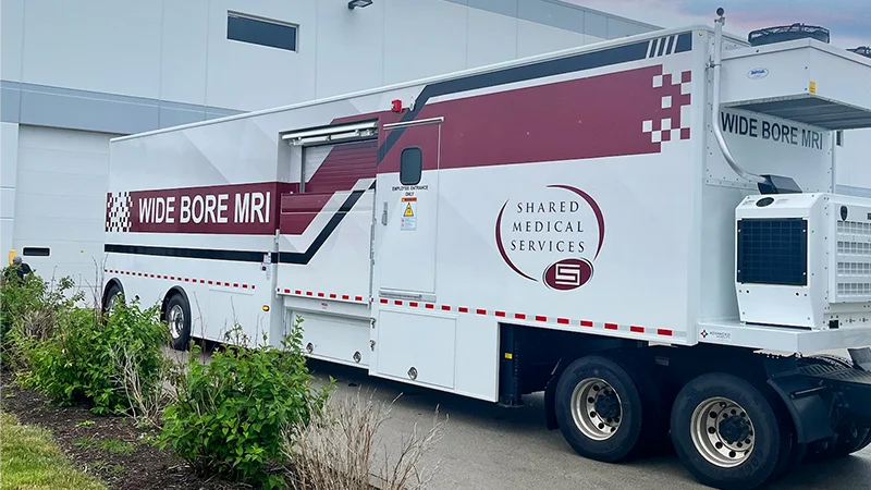 Shared Medical Services mobile wide bore MRI unit parked at healthcare facility, offering flexible diagnostic imaging with patient comfort in mind.
