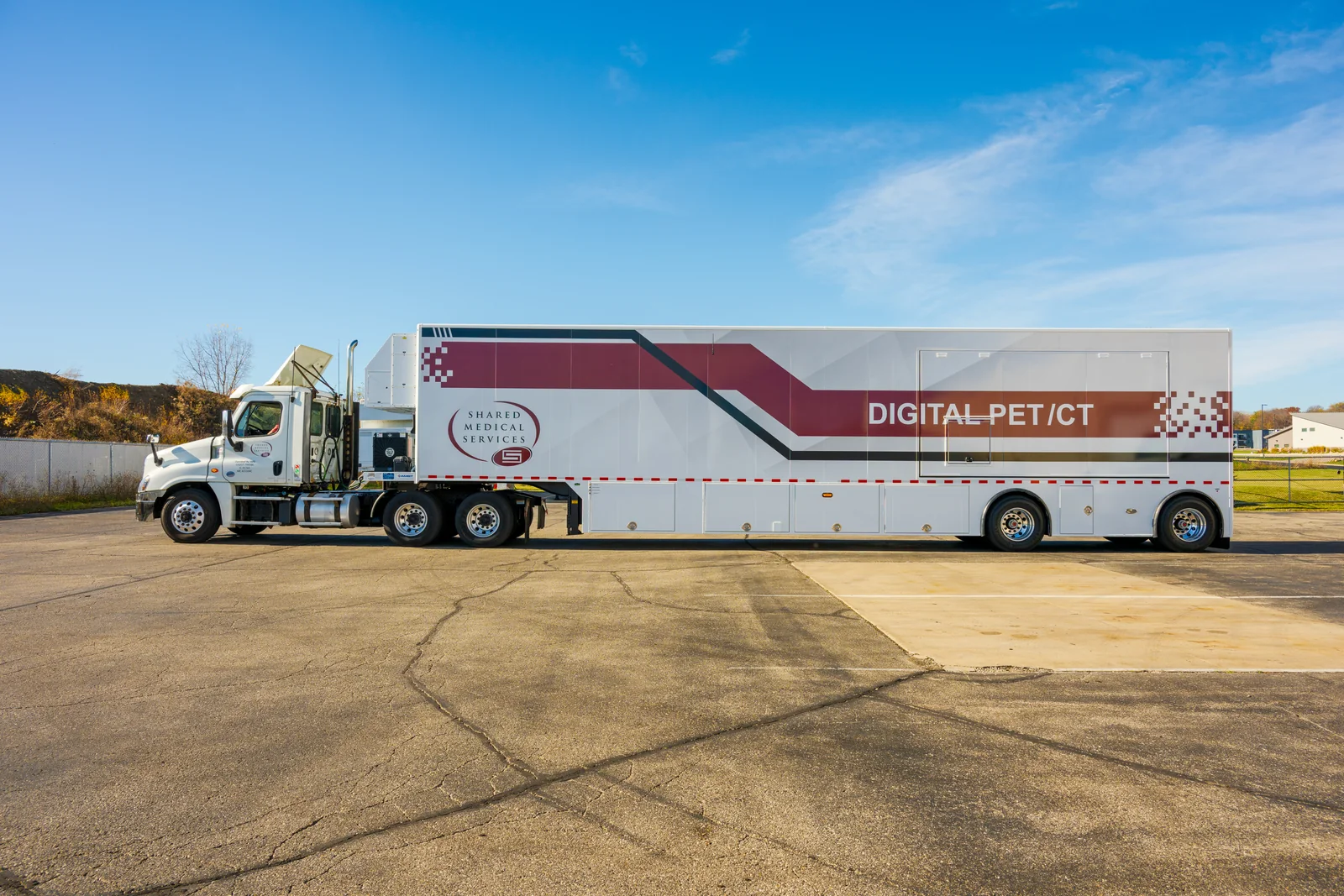 SMS mobile digital PET CT unit side view Side view of an SMS mobile digital PET/CT trailer and tractor on a paved lot.